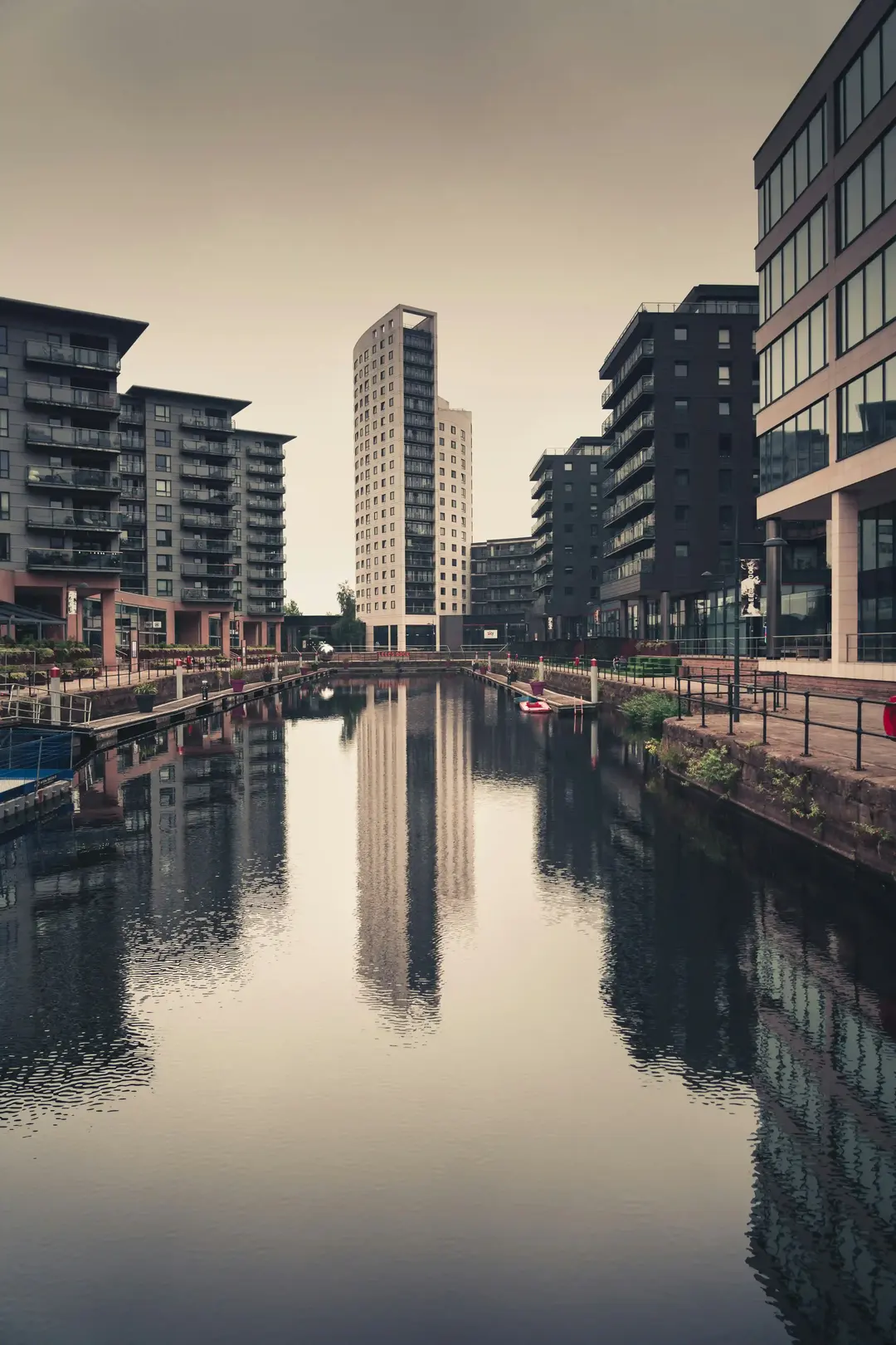 Leeds Dock apartments reflected in the water at dusk