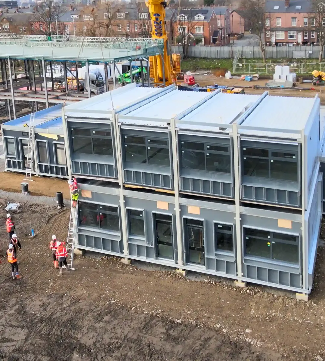 Modular building being installed on site, from the air