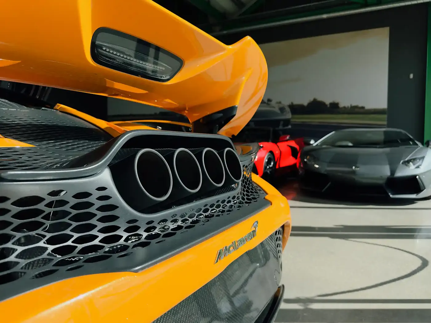 Rear of an orange McLaren showing its exhaust and diffuser