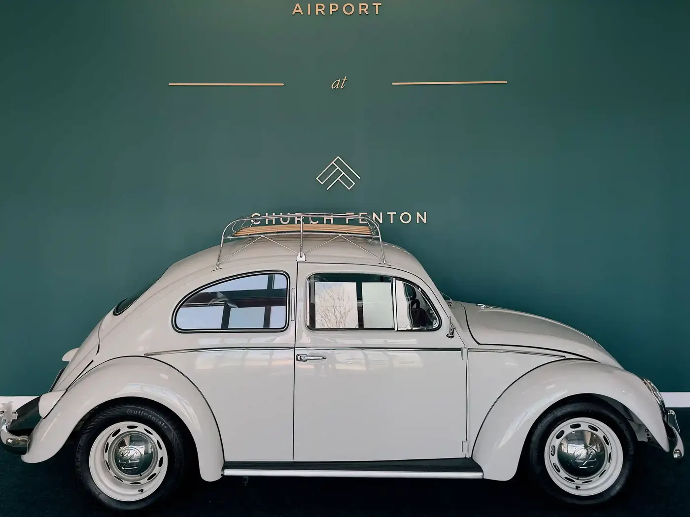 Classic white Volkswagen Beetle displayed at Leeds East Airport