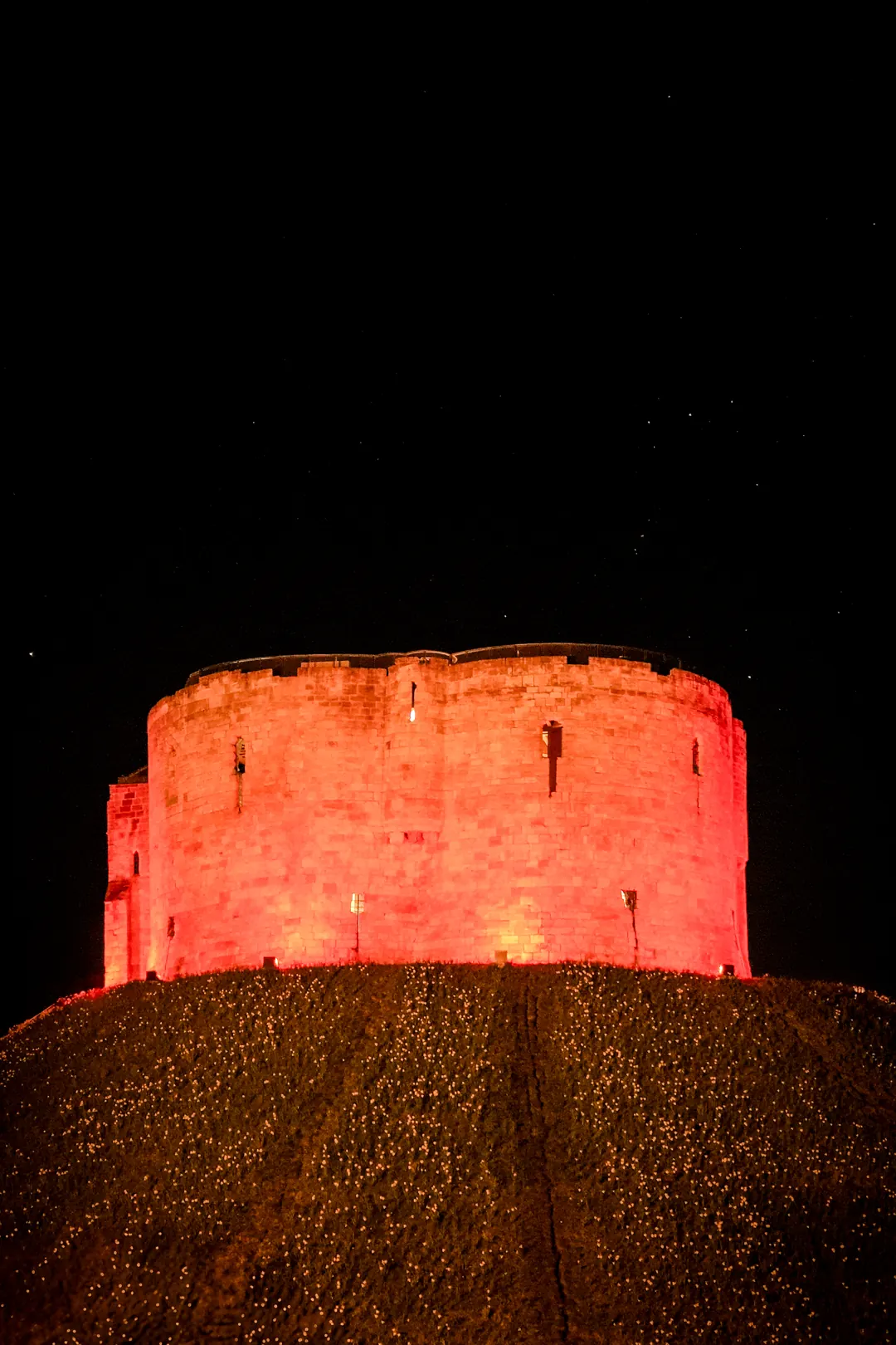 Clifford's Tower in York lit red at night